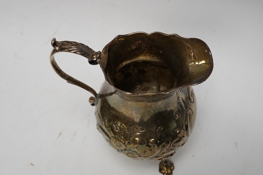 A George III silver cream jug, with later embossed decoration, London, 1766, 12.7cm, 5.7oz. Condition - poor